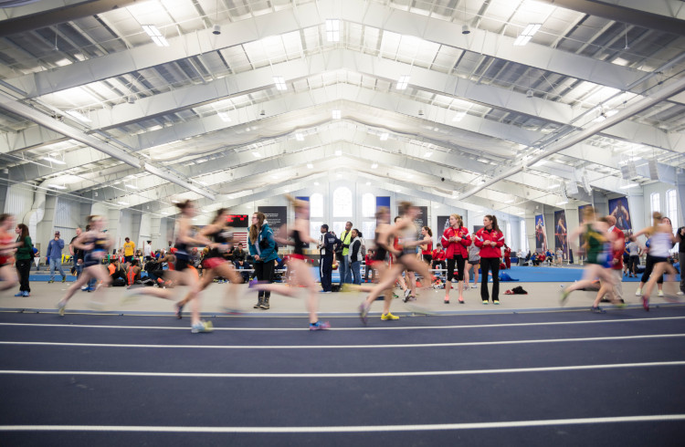 Athletes running on the Margot V. Biermann Athletic Center's indoor track.
